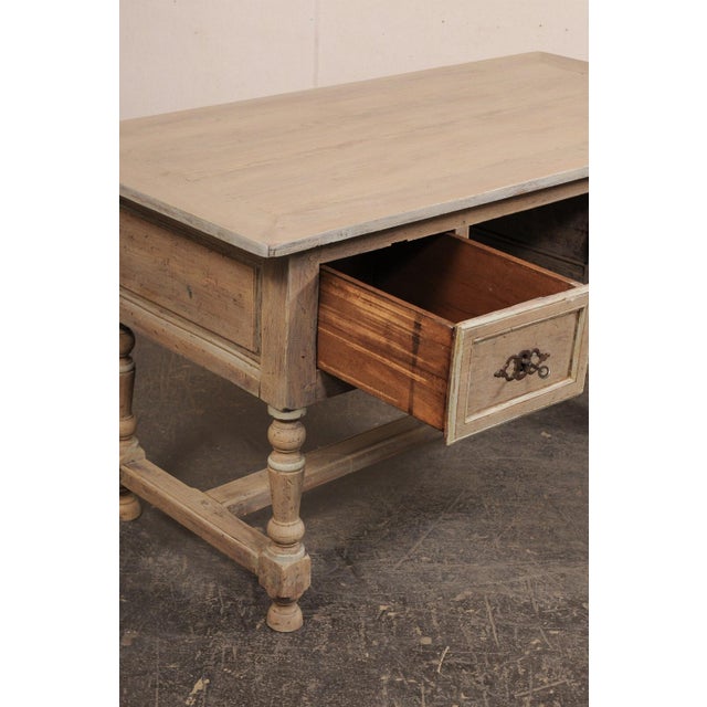 A beautiful French painted wood two-drawer desk, with fabulous shell motif carvings, from the 19th century. This antique...