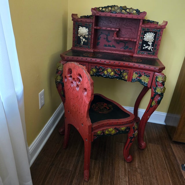 Stunning Japanese red lacquer wood carved writing desk and chair set. The desk has a hutch top with two doors (the door on...