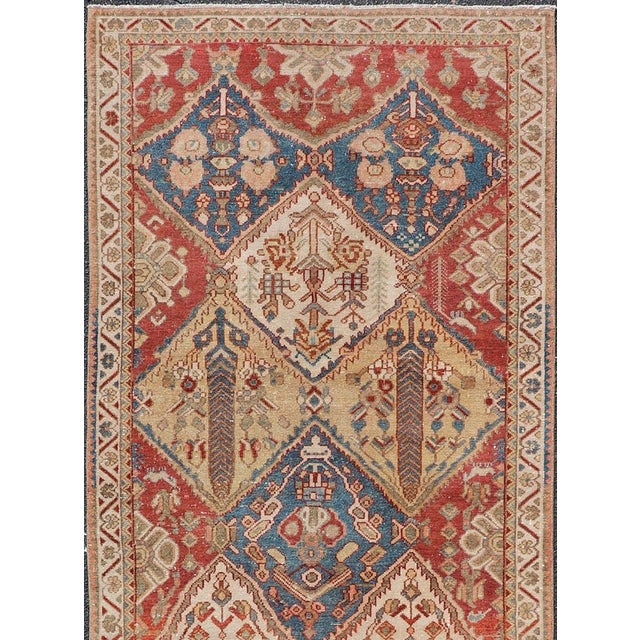 Discover the timeless beauty and robust quality of this antique Persian Bakhtiari runner rug, circa 1930. Crafted in Iran,...