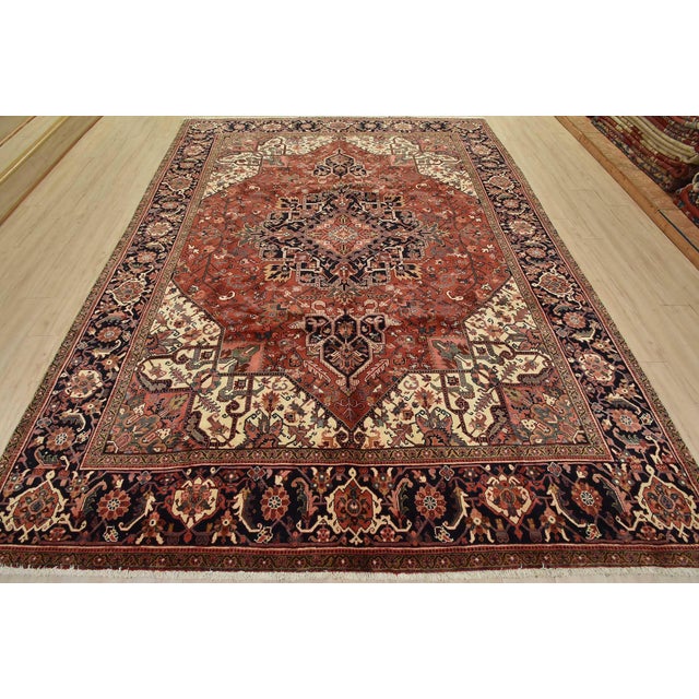 An authentic vintage traditional Heriz rug hand-knotted with fine wool and natural dyes. This oriental rug features a...