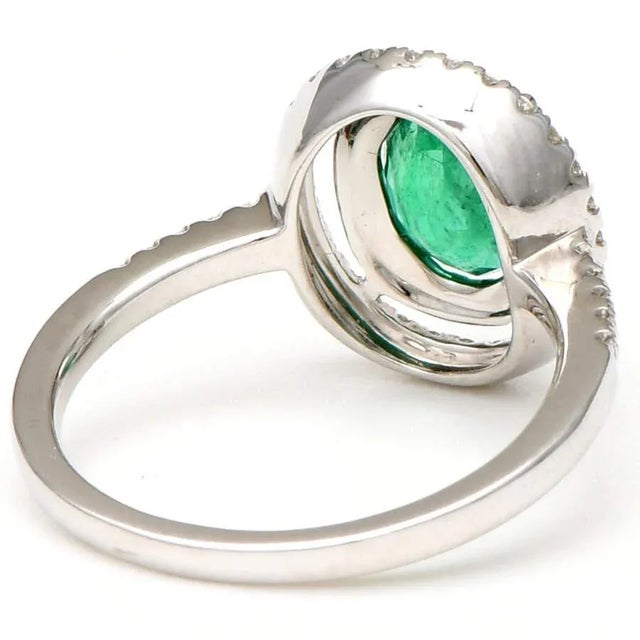 Watch others turn green with envy when you flash this dazzling 14K white gold double halo ring. It boasts a large, oval...
