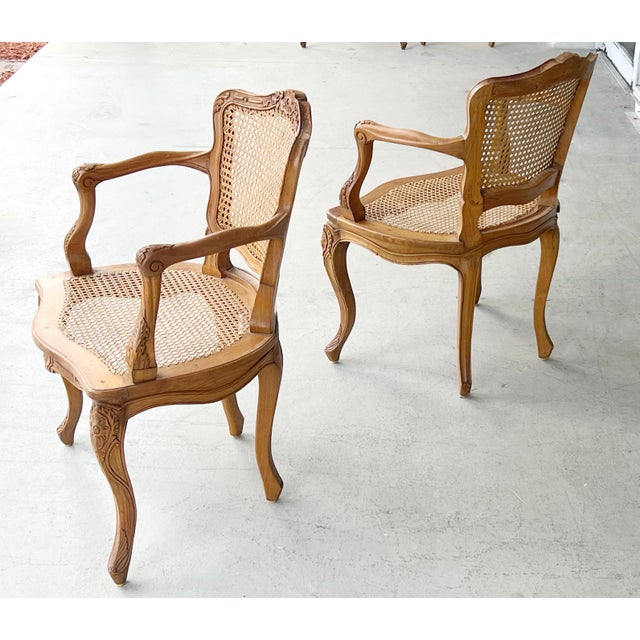 A pair of beautifully crafted chairs by Marie Albert. Hand carved detail and dowel construction, the cane is done in the...