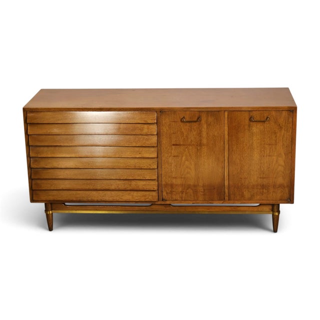 This 1960s American of Martinsville lowboy dresser from the Dania collection, designed by Merton Gershun, carries the...