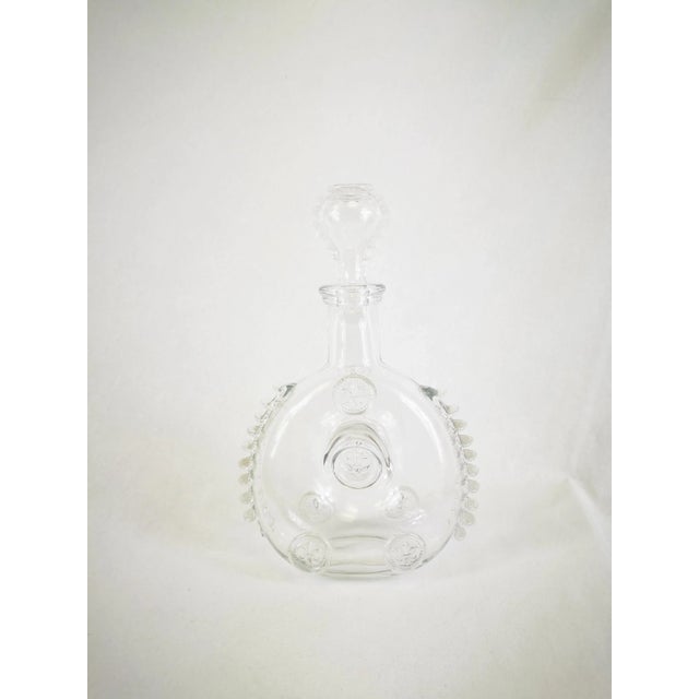 This is a mouth-blown clear crystal decanter, round and flat, with a narrow neck and matching stopper. The model is...