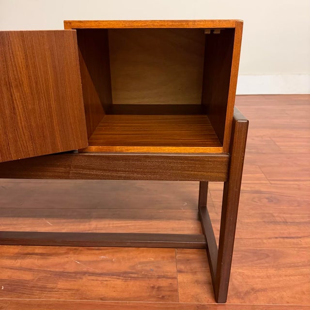Vintage mid-century entry bench with small cabinet and comfortable padded seat covered in black vinyl. Originally designed...