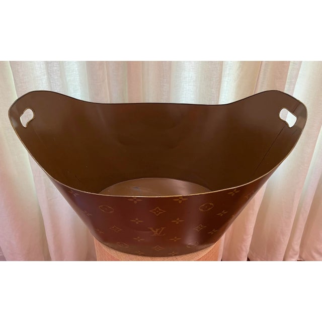 Large tole log holder or bucket. Hand painted with the Louis Vuitton design logo. Brown with gilded edges. Self handles....
