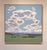 Endless Return captures a serene landscape dominated by expansive skies filled with soft, billowing clouds that evoke a...
