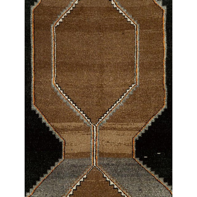 This mid-20th-century Turkish Anatolian wide gallery runner presents a bold, highly architectural composition on a deep...