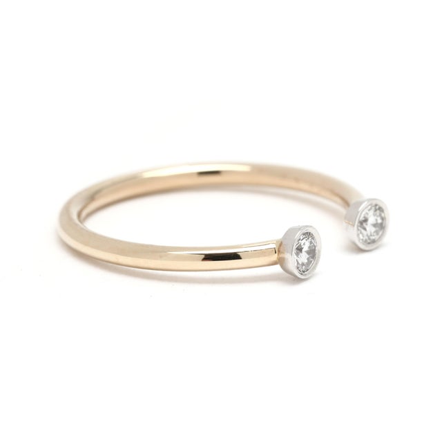 Stones: diamonds, 2 stones round brilliant cut 2.4 mm approximately .12 total carats G-H color, VS1-2 clarity Ring Size:...