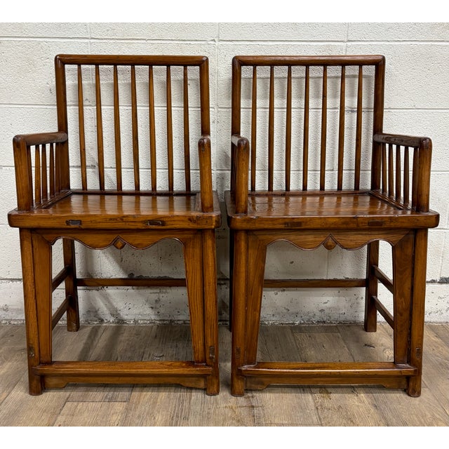 This is a stunning pair of antique Chinese “double happiness” dining arm chairs, believed to be made of walnut, and...