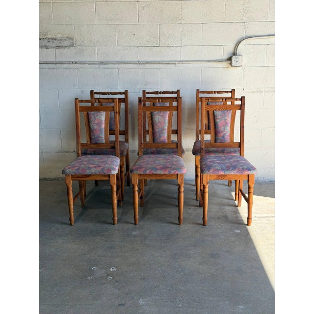 This set of 6 dining chairs showcases turned wooden legs and tall slatted backrests. Vintage 1980s. Crafted from solid...