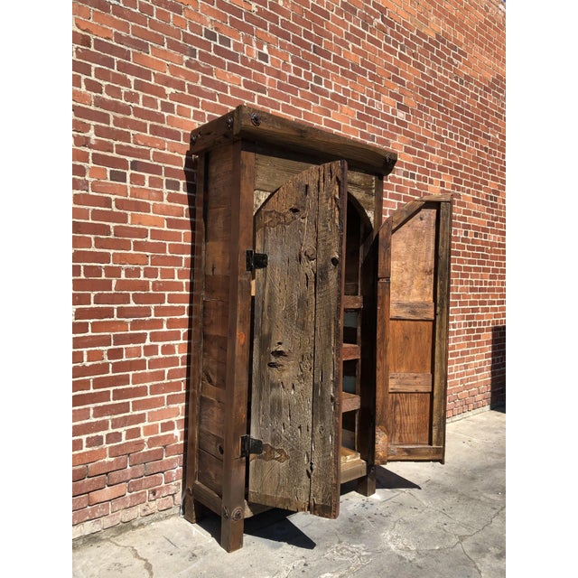 Rustic wooden storage cabinet made from reclaimed wood with a unique vintage style. Features double doors and spacious...