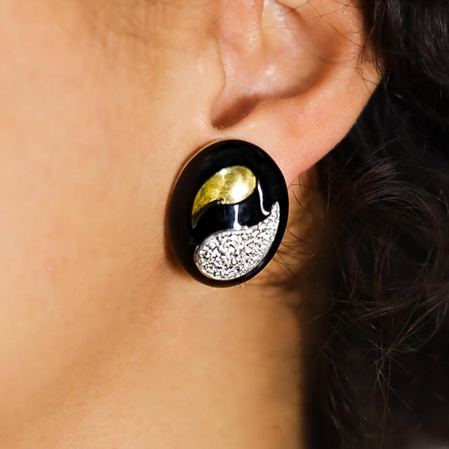 18k Two tone gold black onyx earrings with 0.84 carats of round brilliant diamonds.
