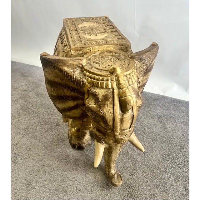 Large Anglo-Indian / Orientalist style sculptural elephant table base crafted in carved resin with an antique gilt finish...