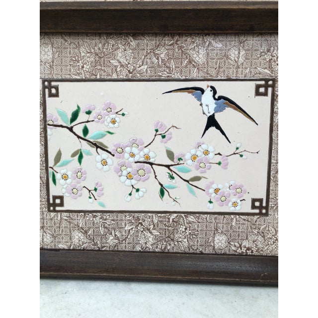 A charming Majolica serving tray with wood and metal handles circa 1890. A scene with a swallow and delicate flowers....