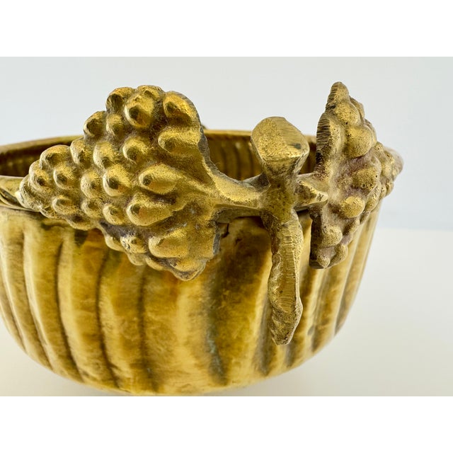 A striking vintage solid brass centerpiece bowl, handcrafted in India and featuring a beautifully textured combination of...