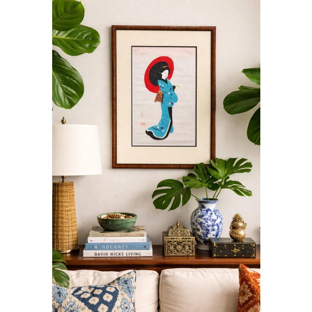 This vintage Japanese decorative artwork features a graceful bijin (beautiful woman) dressed in a turquoise kimono,...