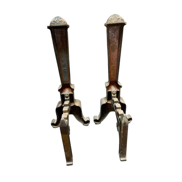 These gold painted cast iron andirons are showstoppers! Perfect for storing wood next to a fireplace. Gold painted circa...