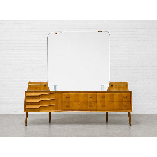 Italian Mid Century Modern Long Dresser + Large Mirror, c. 1960’s. This incredibly unique piece consists of a 7 drawer...