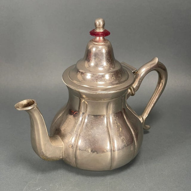 Beautiful and ornate silverplate teapot with wonderful surface character and patina. We had no luck in our research on the...