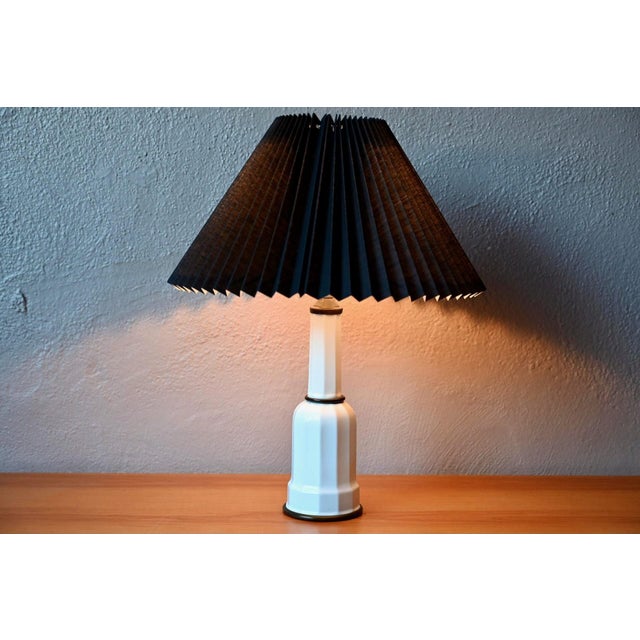 A typical Danish lamp, this lovely specimen in white porcelain and brass dates from the 1960s. with its elegant,...