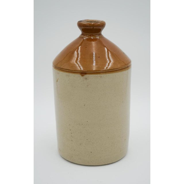 Decorative English Antique Stoneware Jug. Transformed into a charming flower vase, showcases classic craftsmanship from...