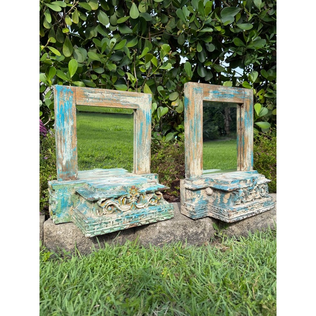 A distinctive pair of vintage wall-mounted shelf mirrors crafted from reclaimed architectural salvage. The richly carved...