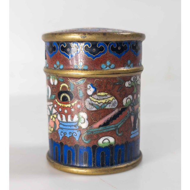 We are selling this Chinese cloisonne enamel covered jar or box. This box has cylindrical form and may have been used for...