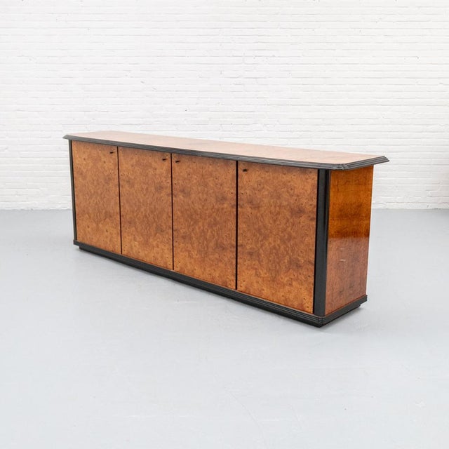 Italian sideboard from the 1980s, finished in high-gloss burl wood veneer with a striking and richly patterned grain. The...