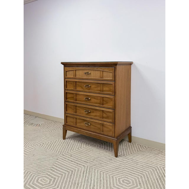 This striking vintage Dixie mid-century modern tallboy dresser is a genuinely appealing and collectible bedroom piece. The...