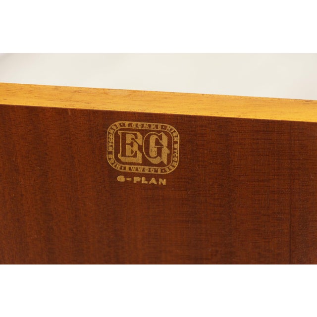 A midcentury brandon range oak credenza piece by g plan, raised on splayed, tapering legs that give the cabinet a light,...