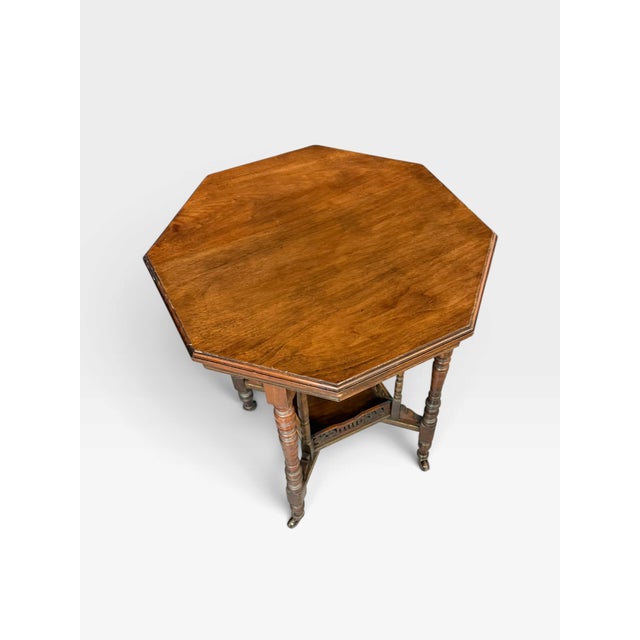 This octagonal occasional table is designed in the Victorian or Edwardian style and dates from approximately 1900....