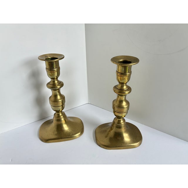 An exceptional pair of antique brass candlestick holders dates to the mid-to-late 19th century. Featuring a classic...