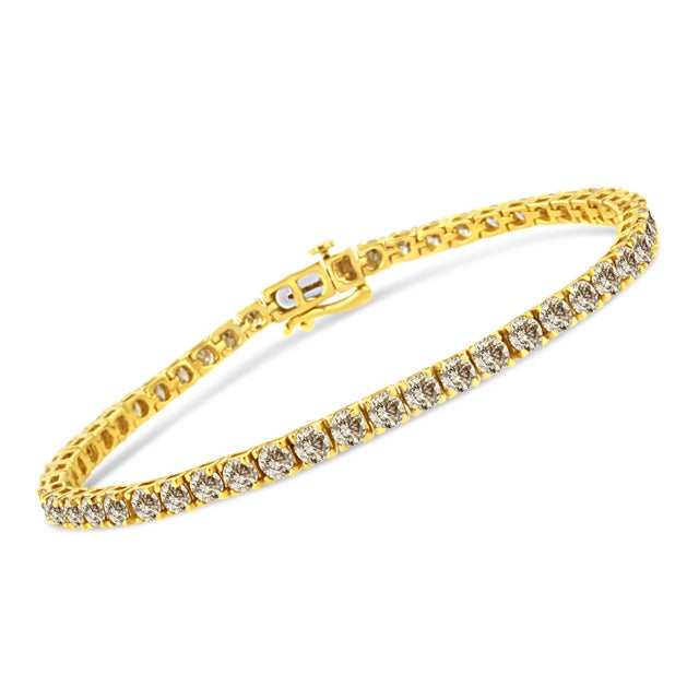 Elegant and timeless, this gorgeous 14 karat yellow gold plated 92.5% sterling silver tennis bracelet features 8.0 carat...