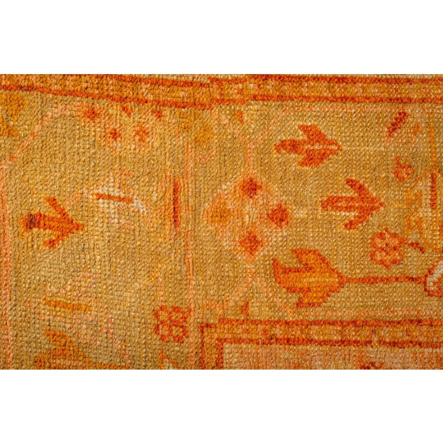 A striking example of Anatolian textile artistry, this antique Turkish Oushak rug (circa 1920) masterfully combines a bold...