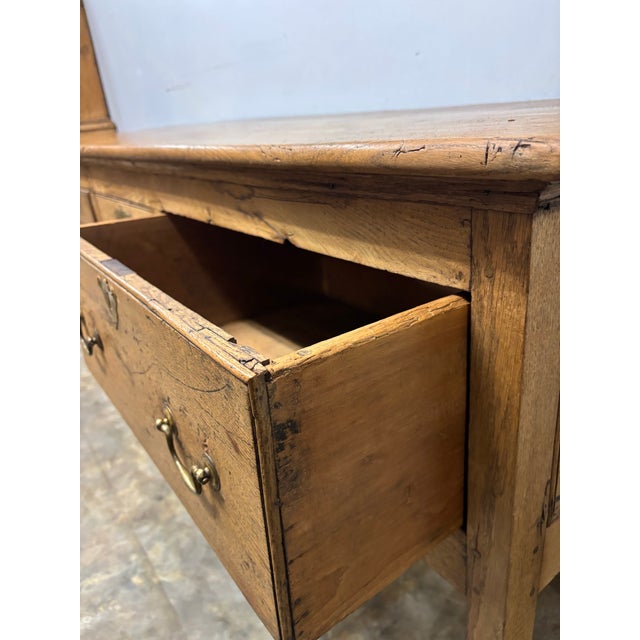 There are some pieces that seem to carry the weight of centuries with remarkable grace. This 18th century English oak...