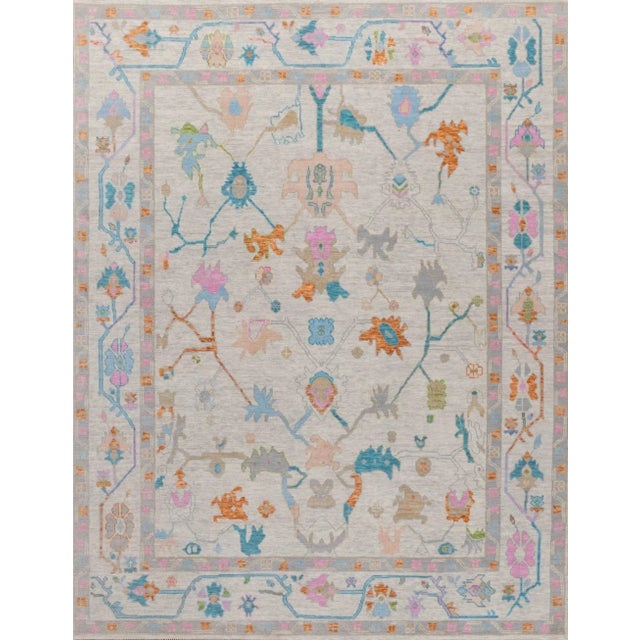 Colorful blue, pink, orange modern handknotted oushak rug As all of our rugs are made by hand, each may have slight...