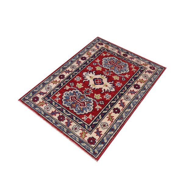 Enhance your home with this exquisite hand-knotted Kazak rug, crafted from fine hand-spun wool and dyed with all-natural...