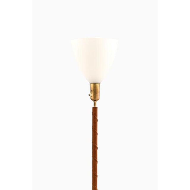 This rare pair of floor lamps, produced by asea in sweden during the 1950s, exemplifies the refined craftsmanship and...
