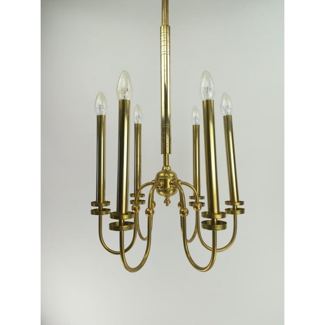 Design chandelier made of brass Surface polished. Version: 6xe14. Re-electrified according to today's security standard....