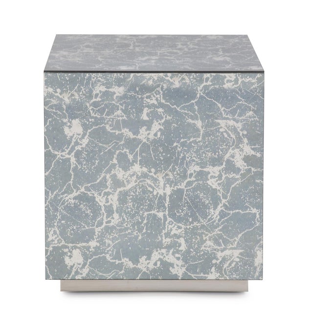 A sleek contemporary cube has been covered in a blueish gray antique mirror to create the Paxton Side Table. With the...