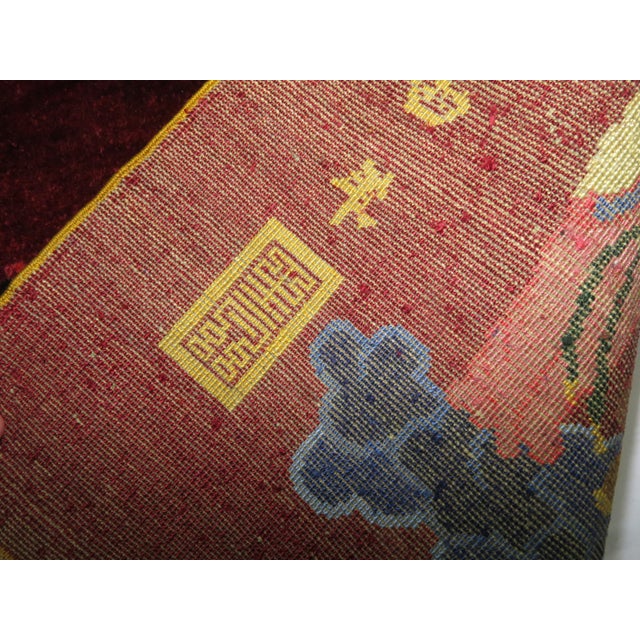 A Chinese silk pictorial rug. On a border-less burgundy red ground, 11 Immortals stand on clouds .Each immortal has its...