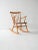 Vintage rocking chair from the 1950s and 1960s with a solid beech frame, a contoured teak seat, and a thin spoked...