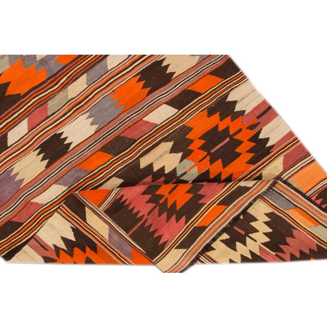 Beautiful Modern Kilim Hand-knotted Wool Rug with a multi-color field in an all-over geometric design. This rug measures...