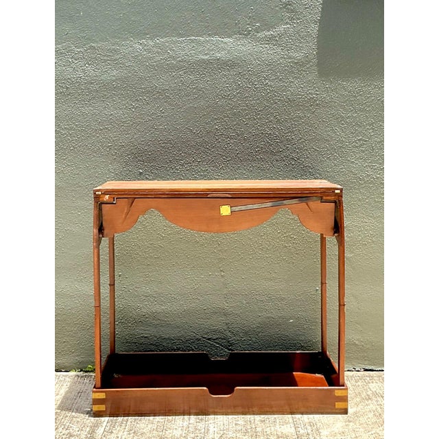 This exceptional vintage English game table embodies the functional elegance of classic campaign furniture, designed with...