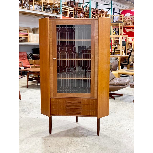 Danish Modern Corner Cabinet or Bar with glass doors. Shelves are not adjustable. 35w 22.5d 57.5h