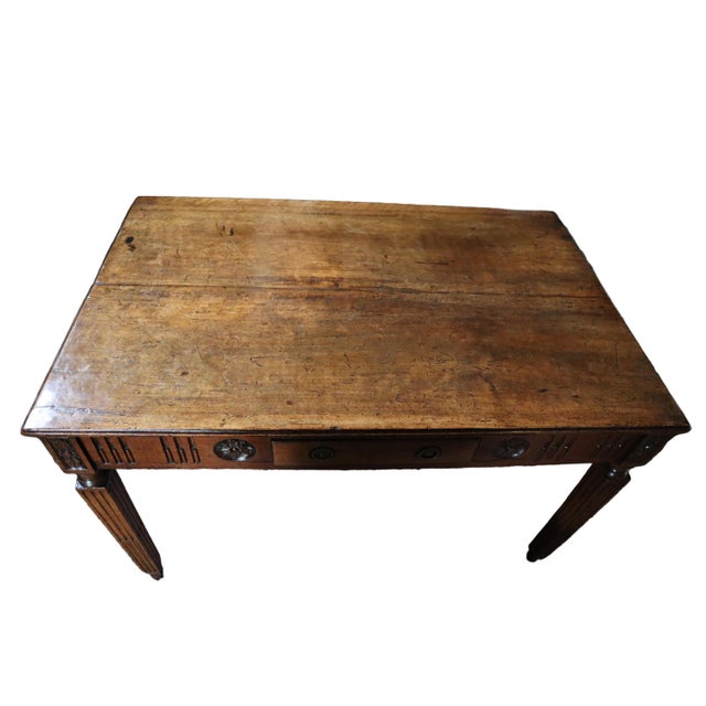 This remarkable 19th century French library table stands on fluted tapered legs and is adorned with intricate floral...