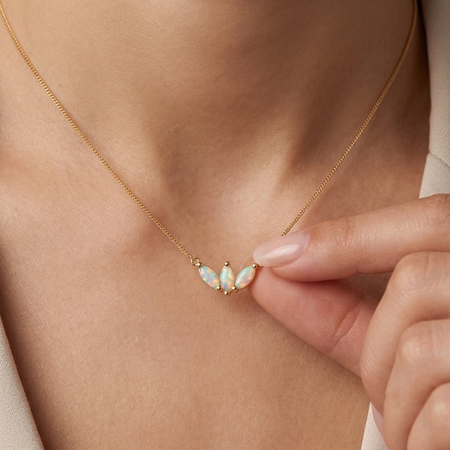Add a touch of ethereal wonder to your jewelry collection with this romantic three-stone pendant necklace, featuring three...
