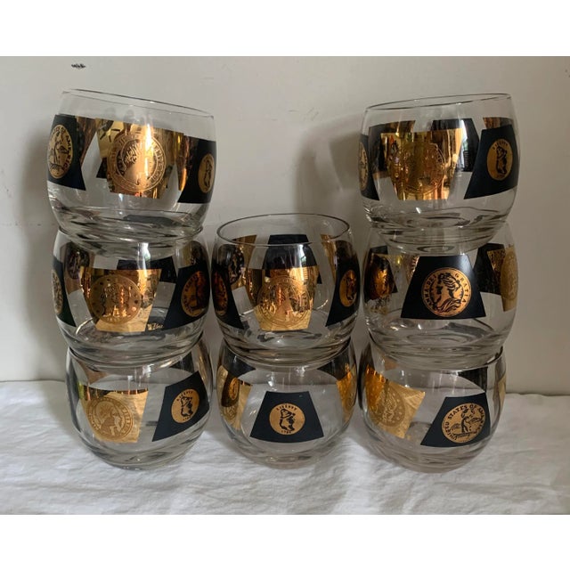 Vintage 1960’s original set of eight glass tumblers. Enameled with black and gold features various coins. Measures 3.5” x...