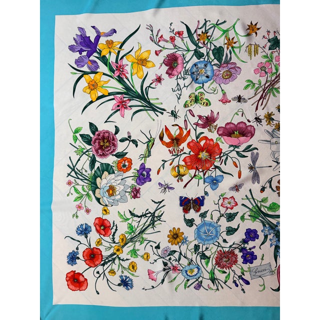 GUCCI FLOWERS AND INSECTS silk scarf 1990 This magnificent scarf is an homage to nature. The flowers, foliage, and insects...